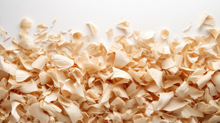 Wood shavings scattered on white surface create textured and natural background, evoking sense of craftsmanship and woodworking