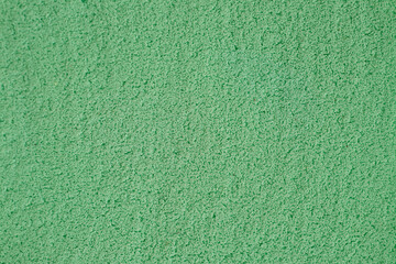 Textured Green Surface With a Soft, Granular Appearance Suitable for Various Applications or Artistic Endeavors
