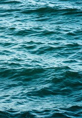 Obraz premium Deep Blue Ocean Water Surface with Gentle Waves in Natural Light