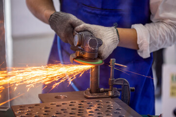 Roofer using a angle grinder to cut a metal.