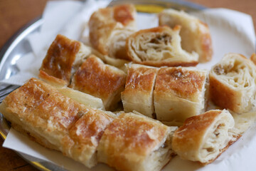 Savory pastry rolls displayed on a silver tray