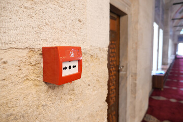 Fire alarm box mounted in a historic building hallway