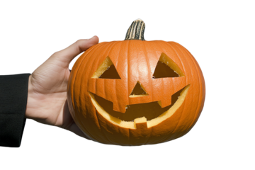 A hand holding a carved Halloween pumpkin with a smiling face, perfect for autumn celebrations and festive decoration.