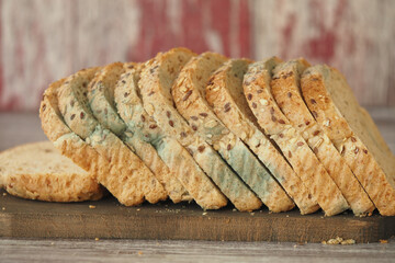 Mold bread on wooden board with rustic background