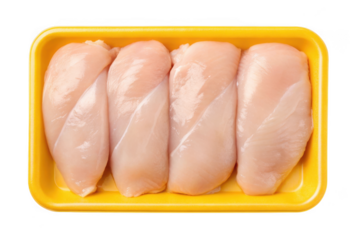 Four raw chicken breasts in a yellow tray isolated on transparent background