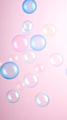 Pastel-colored bubbles float against a pink backdrop