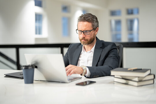 Office worker with laptop at office. Ofice employee remote working in modern office. Businessman have on line meeting. Business man using computer in office. Modern offices workplace.