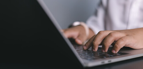 Remote work, technology, and online learning, ideal for business, education, productivity, and modern lifestyle themes. Close-up of hands typing on laptop keyboard.