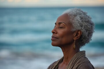 Side profile of a senior black woman meditating and practicing deep breathing exercises on the beach by the sea during summer vacation. Focusing on wellness and mental health, Generative AI