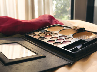 Makeup palette on a white bed. A skin makeup preparation before an event.