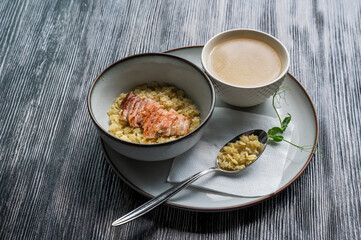Chicken broth with noodles on a wooden table. 