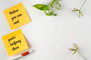 Inspirational Post-It Notes With Motivational Message Surrounded by Greenery and White Space
