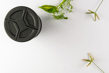 Fake Lens Coffee Mug With Green Plants on White Minimalist Background