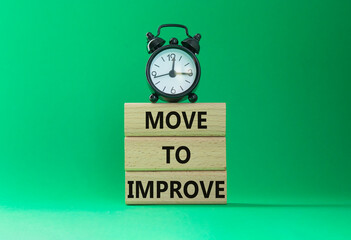 Move to Improve symbol. Concept words Move to Improve on wooden blocks. Beautiful green background...