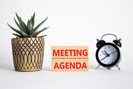 Meeting agenda symbol. Concept word Meeting agenda on wooden blocks. Beautiful white background with alarm clock and succulent plant. Business and Meeting agenda concept. Copy space - Powered by Adobe