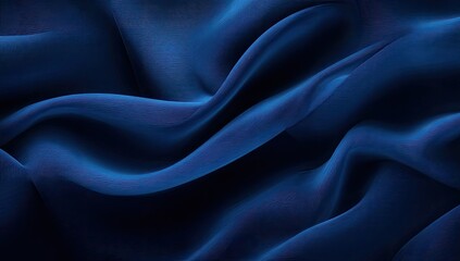 Deep indigo-blue fabric drapes in flowing, wavy folds