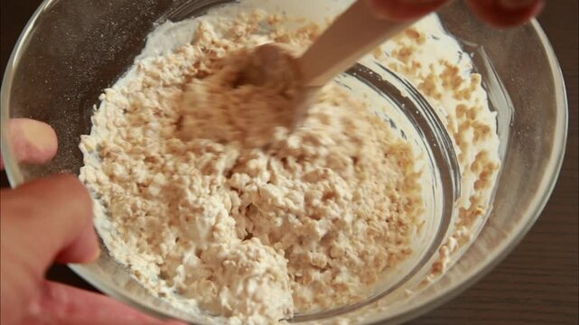 close-up video of mixing oats batter in a bowl for healthy baking recipes, ideal for cooking tutorials, breakfast ideas, and wholesome food preparation