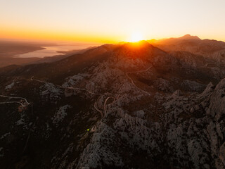 Majstorska road road at mountain Velebit in summer time in Croatia near croatia sea. Rocky peak of Tulove Grede at sunset