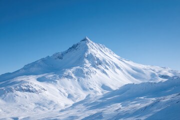 Obraz premium Majestic snow-capped peak rises against clear blue sky, showcasi