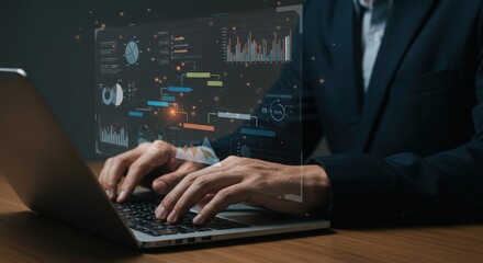 Business professional working on a laptop with futuristic digital interface