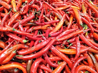 top down view of full frame shoot of big red chilies  or chili peppers. selective focus. showcasing natural ingredient cooking healthy food.