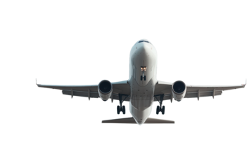 White airplane soaring through clear blue sky with distant clouds above landscape