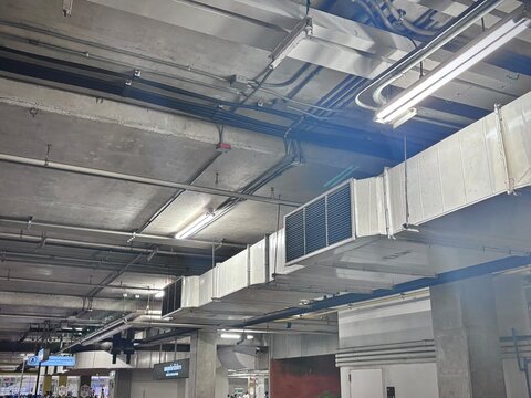 Industrial duct system with ventilation plenum and air grille for factory airflow distribution, ensuring efficient air circulation in manufacturing and warehouse facilities.