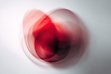 Abstract swirling red shapes on a light background