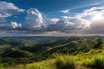 Naklejka premium Panoramic vista of rolling hills, lush greenery, wind turbines, and dramatic clouds