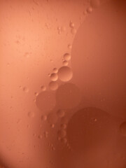 Abstract orange oil and water bubbles macro background