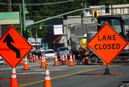 Lane closed sign with traffic and road work