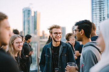 Obraz premium Early evening on a rooftop terrace overlooking a city skyline Youth from different nations gather for an informal networking event