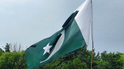A vibrant close-up of the Pakistani flag waving gracefully, its green and white colors accented by the iconic white star and crescent