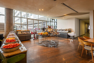 Spacious breakfast room showcasing buffet tables with a variety of served food
