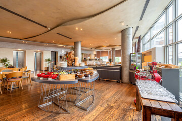 Interior of a breakfast room with buffet tables and served food