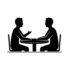 Two men engaged in conversation, seated at a round table, discussing ideas or plans.