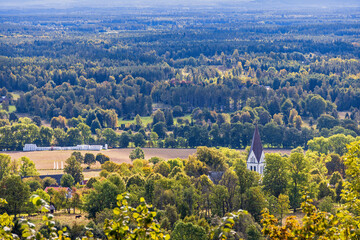 Church steeple above the treetops in the countryside