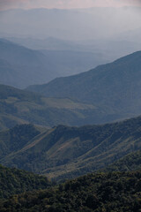Fototapeta premium mountain hills and valley in sunny clear blue sky with flowing white cloud in morning sunshine