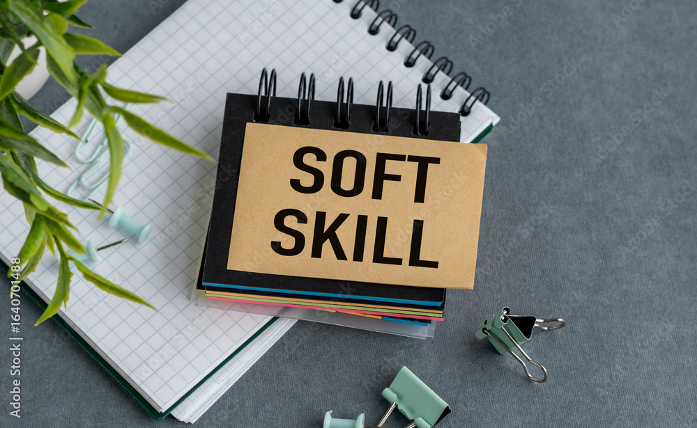 Poster a notebook with a piece of paper that says soft skill on it