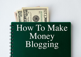 A green spiral notebook with the words How to Make Money Blogging written on it.