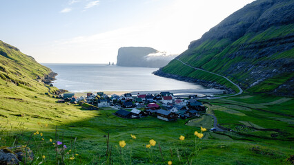 Breathtaking view of a coastal village in the Faroe Islands during golden hour