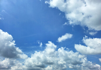 Blue Sky with White Fluffy Clouds. Natural Background for Weather, Nature, and Travel Concepts. High resolution sky texture wallpaper. Clear sunny morning sky.