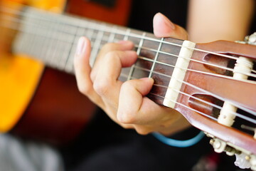 Guitar Playing Techniques: Close-Up Shots. A series of close-up shots of hands playing the guitar, showcasing different finger positions and techniques, perfect for music enthusiasts and instructional