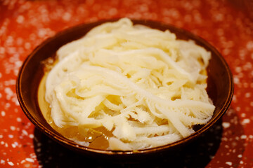 close up of a bowl of sliced raw beef tripe