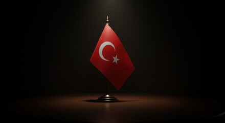 Fototapeta premium Symbol of Turkey: A solitary Turkish flag stands proudly on a polished surface, a symbol of national identity.
