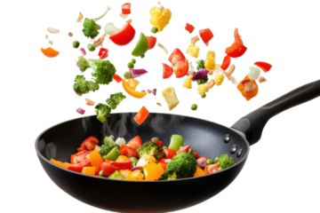 Colorful vegetables falling into a black frying pan during a cooking session in the kitchen