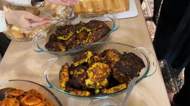 Persian party thanksgiving buffet with grilled sosis bandari adas polo sandwich cake and creamy kashke bademjan Traditional handmade dishes featuring eggplant garlic tangy yogurt and fermented dairy