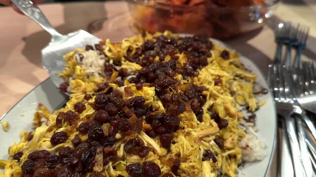 Adas polo rice Persian lentil rice with saffron raisins and fried topping shines at family gatherings Served with salad kashke bademjan and sandwich cake for a delicious party table thanksgiving food