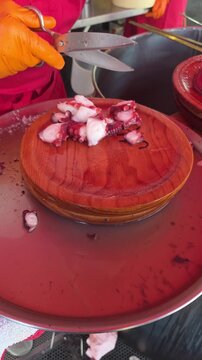hand cutting galician-style octopus at the fair