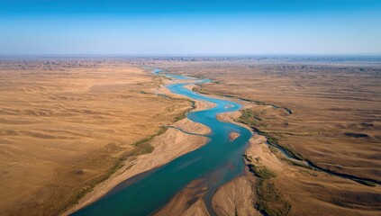 High-angle view of a winding river through a vast, arid landscape